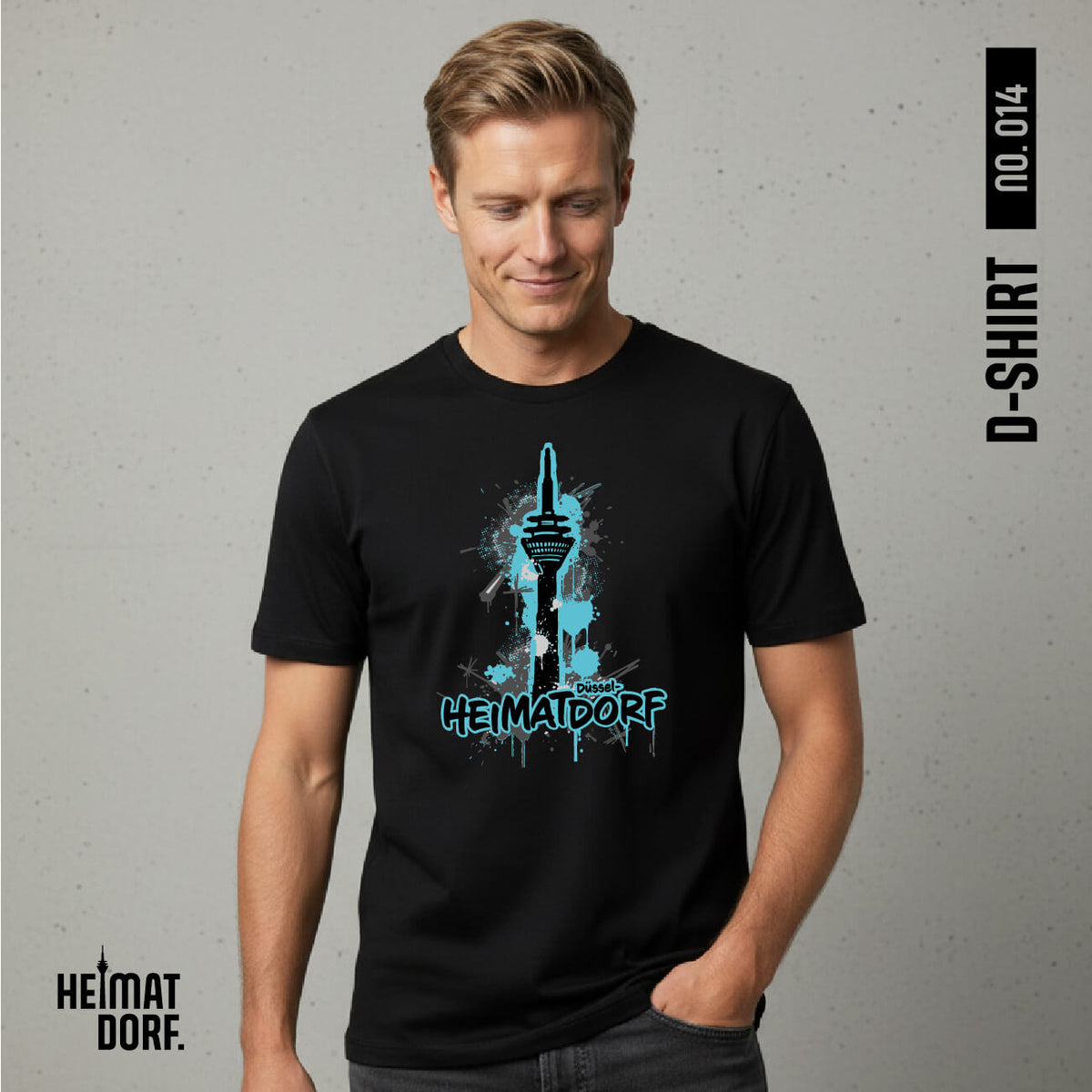 Ein blonder Mann trägt ein schwarzes Relaxed-Fit T-Shirt mit einem Graffiti-Aufdruck des Rheinturms und dem Schriftzug Heimatdorf Düsseldorf mit türkis-blauer Akzentfarbe.